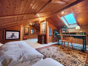 a bedroom with a bed and a desk and a window at Ferienhaus an der Schlierach in Schliersee