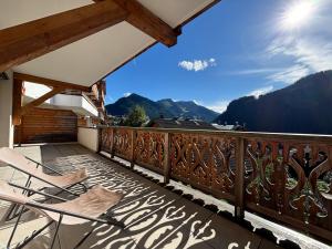 a balcony with chairs and a view of mountains at Perle de Savoie B102 in Châtel