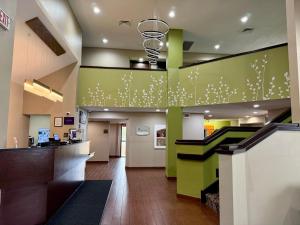a lobby of a hospital with green walls at Sleep Inn Savannah Gateway I-95 in Savannah