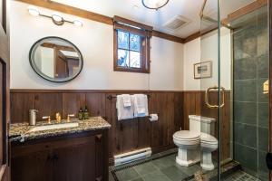 a bathroom with a toilet and a sink and a shower at Altitude 166-1 On the village 9bdr in Mont-Tremblant +36 photos