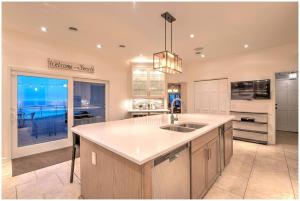 a kitchen with a sink and a large window at Villa Santorini in Gary