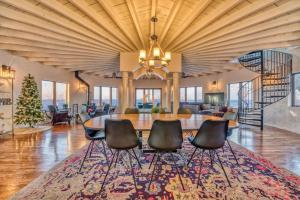 a dining room with a table and chairs on a rug at Villa Santorini in Gary