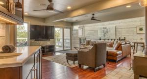 a kitchen and living room with a couch and a table at Villa Santorini in Gary