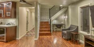 a living room with a staircase and a stair case at Villa Santorini in Gary +36 photos