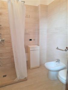 a bathroom with a shower with a toilet and a sink at La Taverna 98 in Otranto +20 photos
