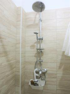 a shower with a shower head in a bathroom at La Taverna 98 in Otranto