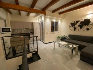 a living room with a couch and a table at Gelsomino in Collina in Vasia