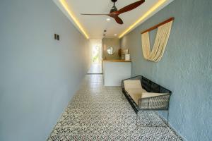 a hallway with a couch and a ceiling fan at Hotel Paso del Mar Playa del Carmen in Playa del Carmen