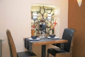 a dining room table with chairs and a lamp at Zava Boutique Hotel Central in Bucharest