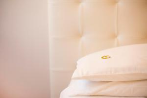 a white blanket on a white bed at Hotel Carlton in Pescara