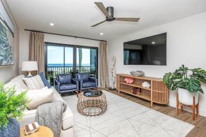 a living room with a couch and a tv at Stylish 2BR Sanibel Condo With Amazing Beach Views 5C2 in Sanibel