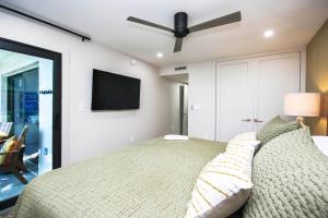 a bedroom with a bed with a ceiling fan at Stylish 2BR Sanibel Condo With Amazing Beach Views 5C2 in Sanibel +20 photos