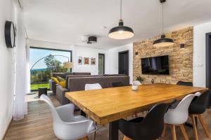 沃拉里Apartmány Na výsluní Šumava - U lípy的配有木桌椅的餐厅和客厅