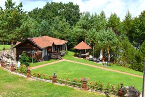 a garden with a gazebo and a house at Sodyba Ciciriai in Vėdariai
