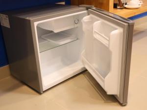 an empty refrigerator with its door open in a kitchen at Moya Boutique Hotel in Betong