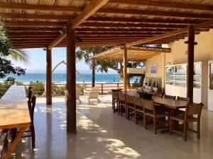 a patio with a table and chairs and the ocean at Casa Pacifico in Los Órganos