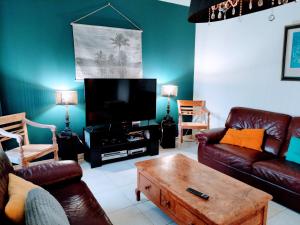 a living room with a couch and a coffee table at kerwatt - Grande et belle maison de ville avec jardin, proche centre et mer in Cabourg