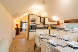 a dining room with a table and chairs in a kitchen at Caddy Lodge in Wisbech