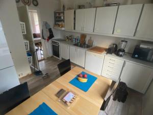 a kitchen with a table with a bowl of fruit on it at 200 M TIL ALT to everything in Egersund