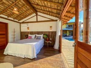 Ένα ή περισσότερα κρεβάτια σε δωμάτιο στο Pousada Refúgio Verde Trancoso