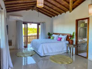 Ένα ή περισσότερα κρεβάτια σε δωμάτιο στο Pousada Refúgio Verde Trancoso