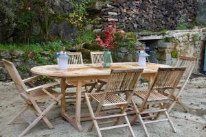 a wooden table with four chairs around it at Villa Antoinette in Saint-Nectaire