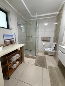 a bathroom with a shower and a toilet at 1 Bedroom Marina Bay Apartment 7 in Durban +8 photos