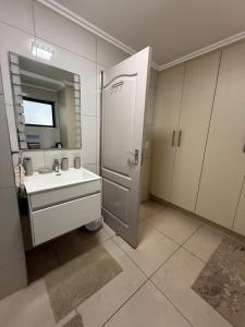 a bathroom with a sink and a mirror at 1 Bedroom Marina Bay Apartment 7 in Durban +9 photos
