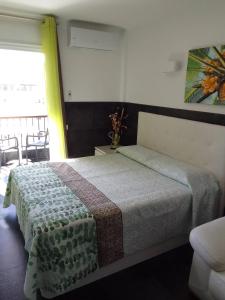 a bedroom with a bed in a room with a window at Modern Studio with Sea View in Arona 40 m² with Balcony in Arona +10 photos