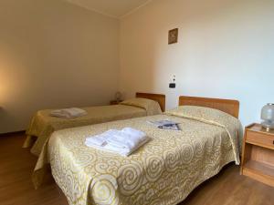 Postel nebo postele na pokoji v ubytování Hotel Ristorante SASSO