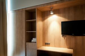 a room with a tv in a wooden wall at Metropolis Hotel in Serres
