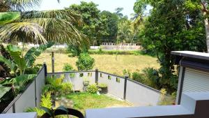 a backyard with a fence and a yard at Villa Meghana in Galle