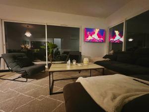 a living room with a couch and a table at villa I Cresti calme confort emplacement idéal et tres belle vue in Ajaccio