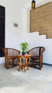 three chairs and a table with a potted plant on it at Sunset Villa in Unawatuna +38 photos