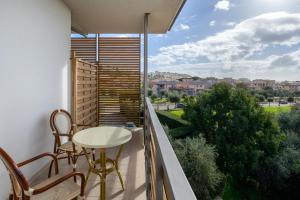 a balcony with a table and chairs and a view at Elaia Garden Hotel in Sperlonga