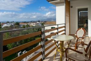 a balcony with a table and chairs and a view at Elaia Garden Hotel in Sperlonga