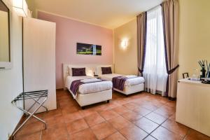 Postel nebo postele na pokoji v ubytování Hotel Bella Firenze