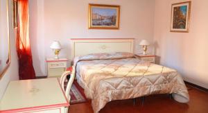 a bedroom with a bed with two tables and two lamps at Best Holidays Venice in Venice