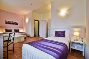Postel nebo postele na pokoji v ubytování Hotel Bella Firenze