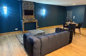 a living room with a couch and a table at Bliss in Langres