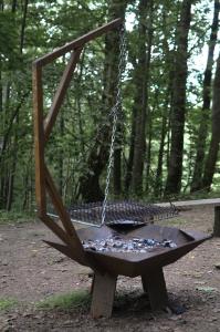 a swing seat in a park with trees at Treehouse Velké Losiny in Velké Losiny