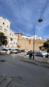 a street light next to a parking lot with cars at Private Room in Kasbah - Old Medina 1 in Tangier