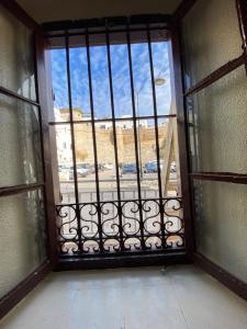 an open window with a view of a street at Private Room in Kasbah - Old Medina 1 in Tangier