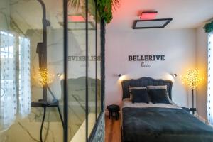 a bedroom with a bed and a glass wall at BelleRive Love Room in Publier
