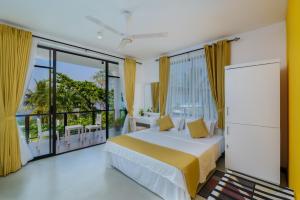 a bedroom with a bed and a large window at Villa Tamerin in Panadura +20 photos
