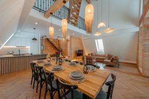 a large dining room with a long table and chairs at Black Raven Cabin in Topliţa +23 photos