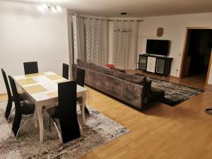 a living room with a couch and a table at Lounge house in Burgau