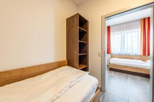 Łóżko lub łóżka w pokoju w obiekcie Wels Inn Hotel