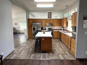 a kitchen with wooden cabinets and a white counter top at Rosie's Surf Shack in Aberdeen