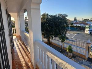 a balcony of a house with a white fence at Apartamentos de la mansión in Carmona